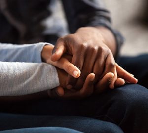 Two people holding hands