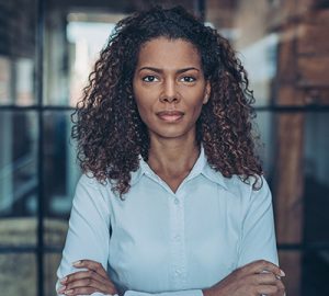 A woman of colour with her arms crossed