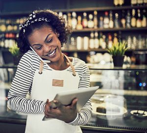 A restaurant owner talking on her mobile phone