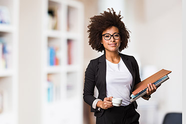 A woman of color with files in hand