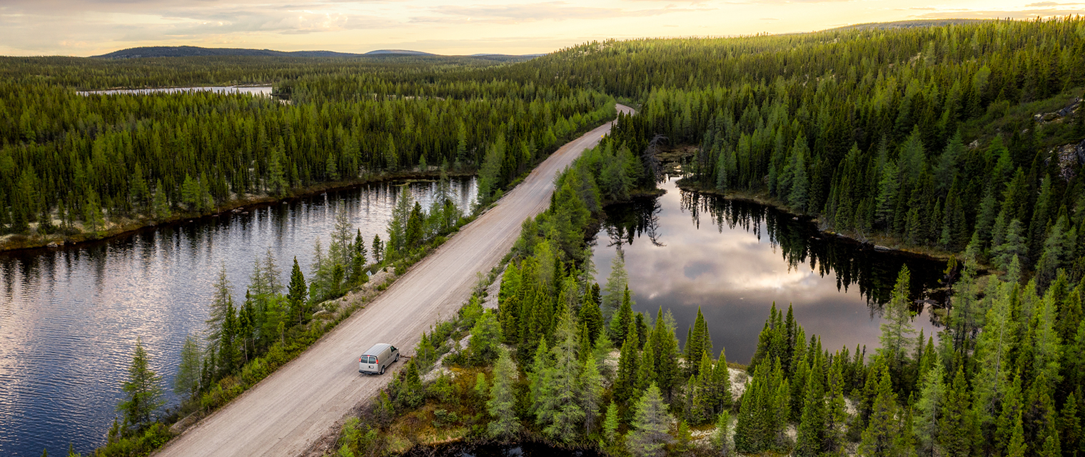 Car driving on a highway surrounded by water