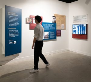 A man looking at the Vancouver Chinatown Foundation display